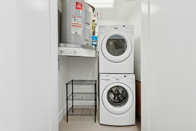 222 W Ave Unit 2109, Austin, TX 78701 - laundry room featuring estacked washer and dryer, electric water heater, and tile patterned floors
