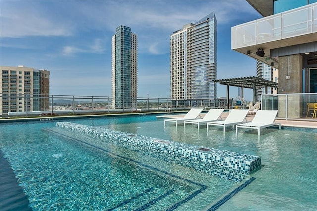 community pool featuring a city view and a pergola