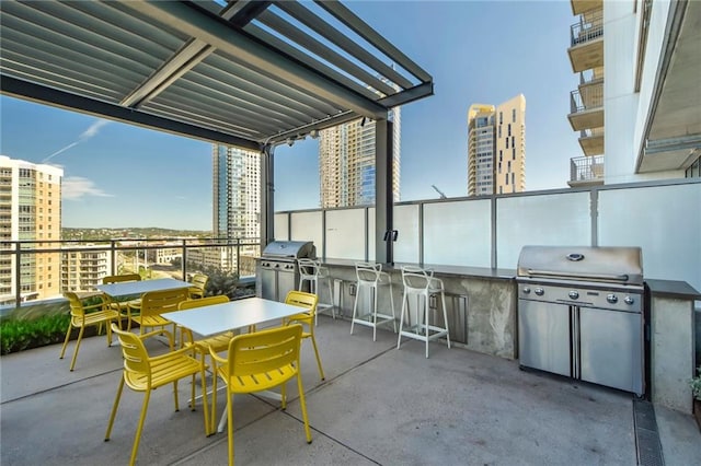 view of patio featuring grilling area, a view of city, outdoor dining area, and area for grilling