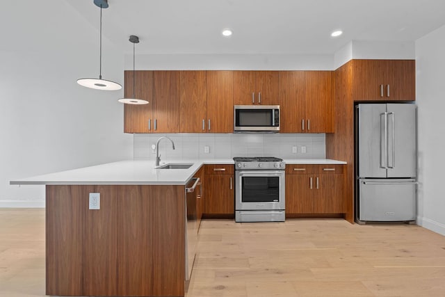 222 W Ave Unit 2109, Austin, TX 78701 - kitchen with stainless steel appliances, a sink, brown cabinets, light countertops, and backsplash
