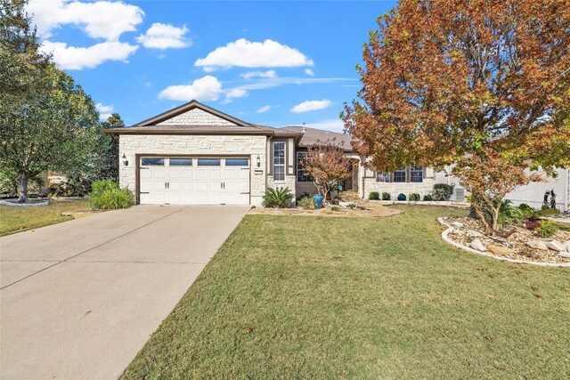 214 Apache Mountain Ln, Georgetown, TX 78633 - ranch-style house with an attached garage, a front yard, driveway, and stone siding