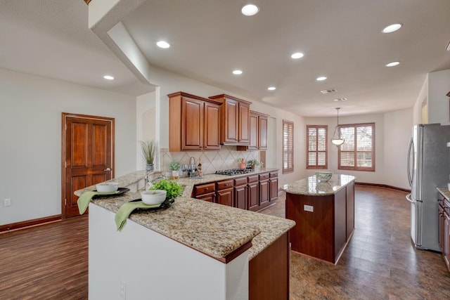 214 Apache Mountain Ln, Georgetown, TX 78633 - kitchen with baseboards, a peninsula, appliances with stainless steel finishes, and a kitchen island