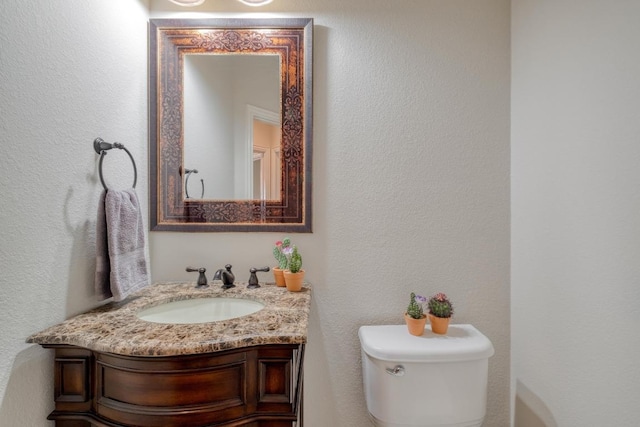 214 Apache Mountain Ln, Georgetown, TX 78633 - half bathroom featuring vanity, a textured wall, and toilet