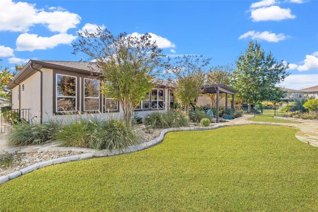 214 Apache Mountain Ln, Georgetown, TX 78633 - rear view of property featuring a lawn, a gazebo, fence, and stucco siding