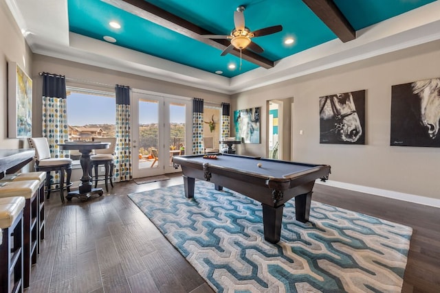 game room featuring a tray ceiling, ceiling fan, and wood finished floors