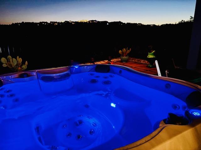 view of swimming pool featuring a hot tub