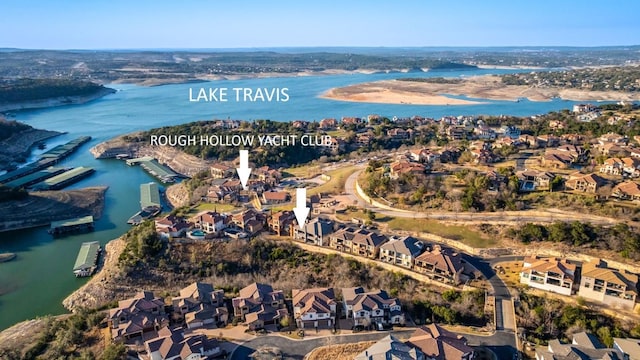 birds eye view of property with a water view and a residential view