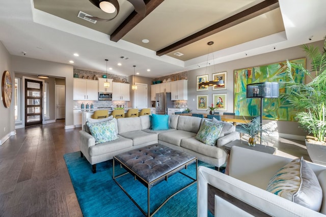 living area featuring dark wood-style floors, baseboards, visible vents, beam ceiling, and a raised ceiling