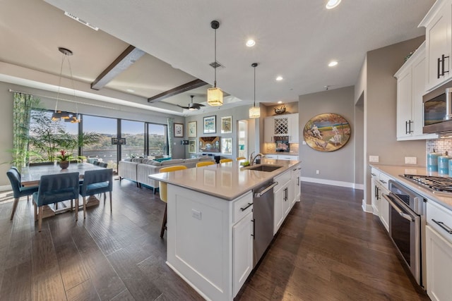 kitchen featuring tasteful backsplash, stainless steel appliances, light countertops, and dark wood-type flooring