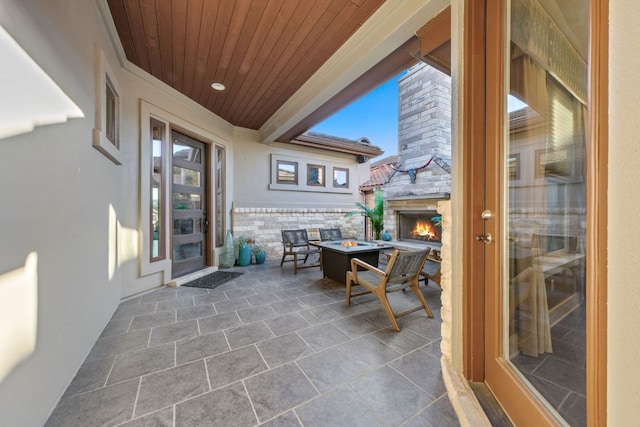 view of patio / terrace with an outdoor stone fireplace