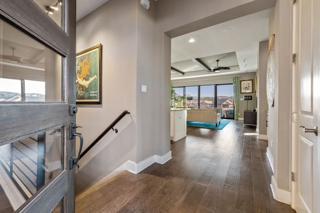 foyer entrance with baseboards and dark wood-style flooring