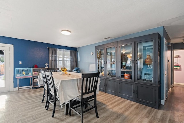 10505 Ruidosa St, Austin, TX 78719 - dining area featuring light wood-style floors, visible vents, and baseboards
