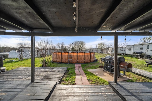 10505 Ruidosa St, Austin, TX 78719 - wooden terrace with grilling area, a lawn, and fence