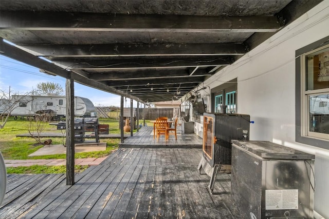 10505 Ruidosa St, Austin, TX 78719 - wooden deck with outdoor dining space and fence