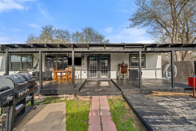 10505 Ruidosa St, Austin, TX 78719 - exterior space featuring a deck, french doors, and stucco siding