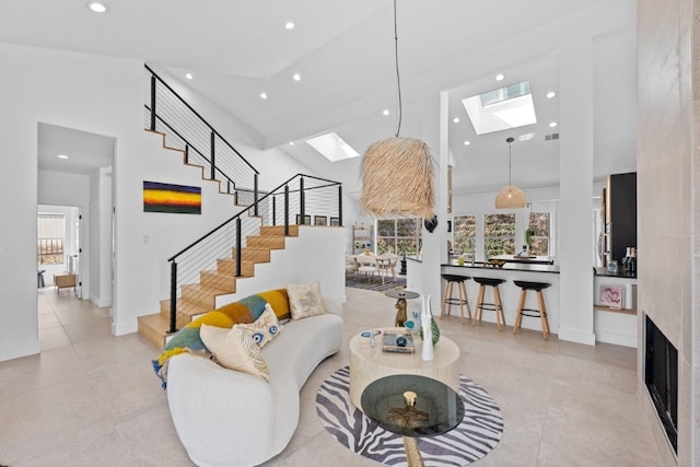 203 Golf Crest Ln, Lakeway, TX 78734 - living area featuring a skylight, high vaulted ceiling, recessed lighting, stairway, and healthy amount of natural light