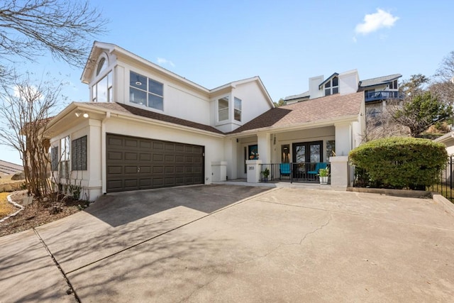 203 Golf Crest Ln, Lakeway, TX 78734 - view of front of property with stucco siding, concrete driveway, an attached garage, and french doors