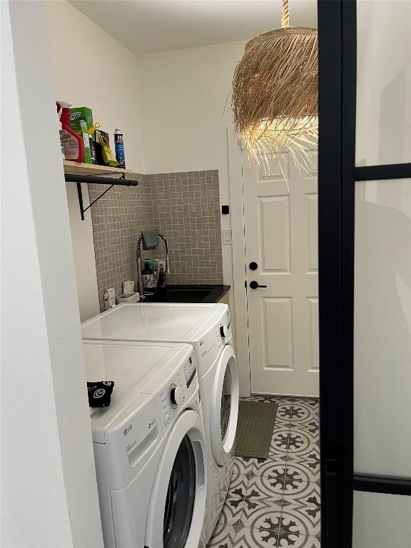203 Golf Crest Ln, Lakeway, TX 78734 - laundry area featuring washing machine and clothes dryer and light tile patterned floors