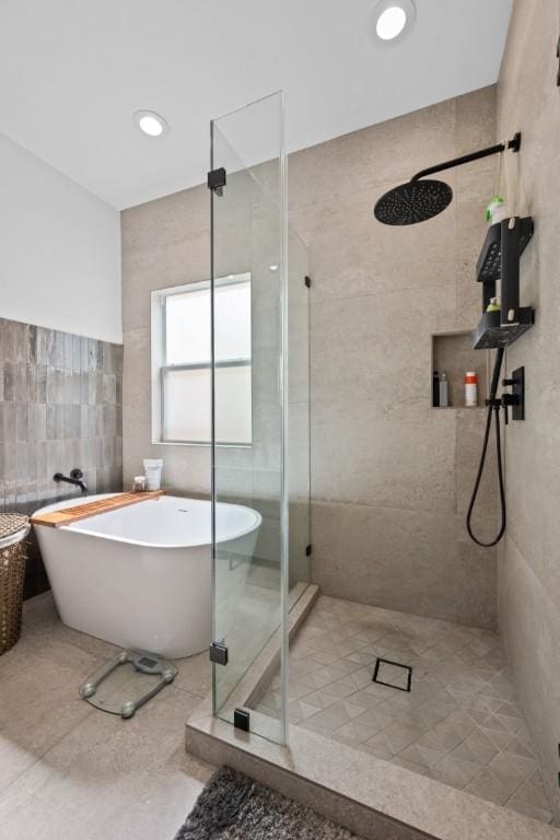 203 Golf Crest Ln, Lakeway, TX 78734 - full bath featuring a shower stall, tile walls, and a freestanding bath