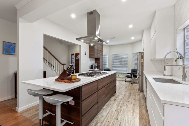 10914 Sierra Oaks, Austin, TX 78759 - kitchen featuring island range hood, modern cabinets, a sink, stainless steel appliances, and white cabinets
