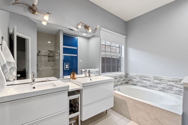 10914 Sierra Oaks, Austin, TX 78759 - full bath with a shower stall, a bath, two vanities, and tile patterned floors