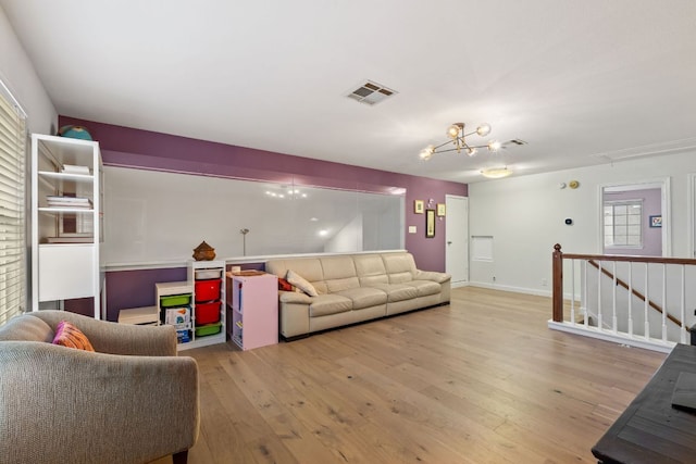 10914 Sierra Oaks, Austin, TX 78759 - living area with attic access, light wood-type flooring, and a chandelier