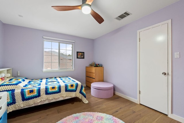 10914 Sierra Oaks, Austin, TX 78759 - bedroom with wood finished floors, baseboards, and a ceiling fan