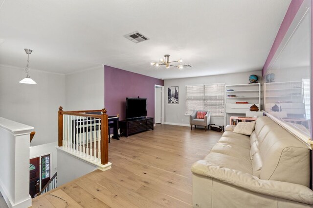 10914 Sierra Oaks, Austin, TX 78759 - living room featuring light wood finished floors, a chandelier, and baseboards