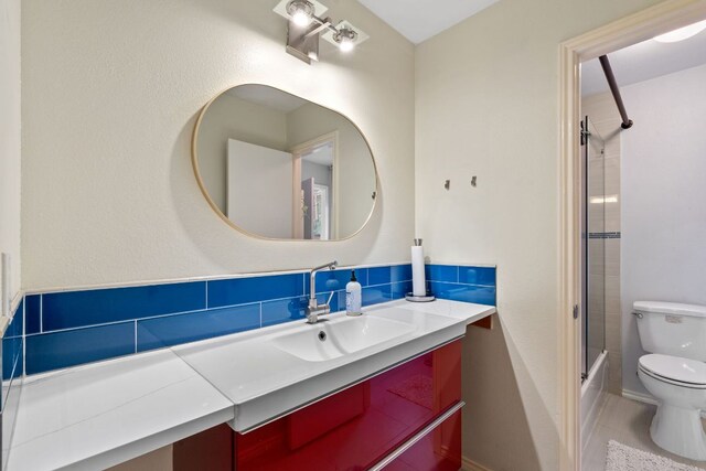 10914 Sierra Oaks, Austin, TX 78759 - bathroom featuring toilet, vanity, shower / bath combination with glass door, decorative backsplash, and tile patterned flooring