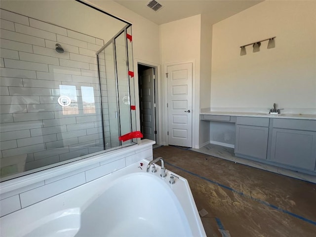 bathroom with a sink, a stall shower, a garden tub, and visible vents