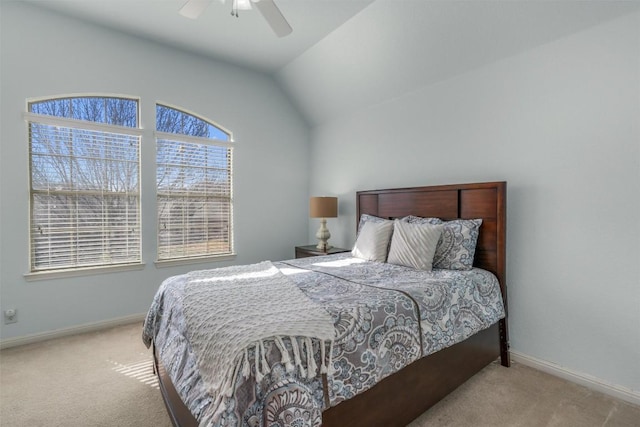 carpeted bedroom featuring ceiling fan, baseboards, and lofted ceiling