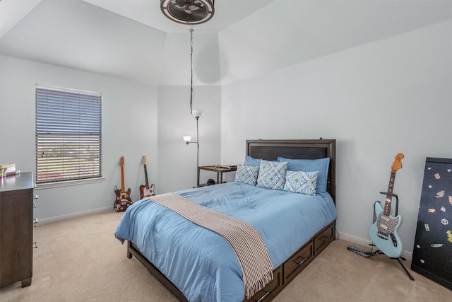 bedroom featuring light colored carpet, lofted ceiling, and baseboards