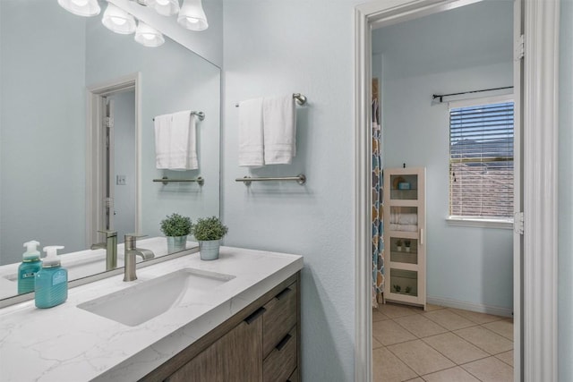 bathroom featuring vanity, tile patterned floors, and baseboards