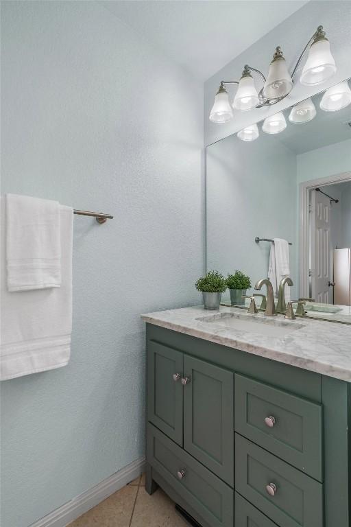 bathroom featuring baseboards, vanity, and tile patterned flooring