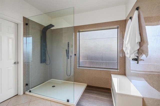 bathroom with tile patterned floors and walk in shower