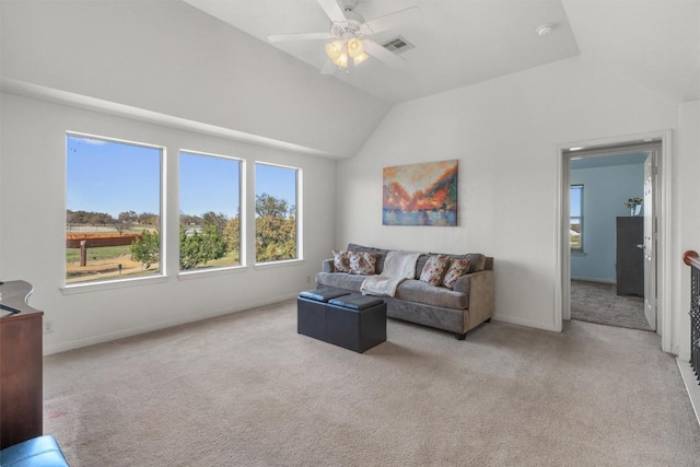 carpeted living room featuring vaulted ceiling, a ceiling fan, visible vents, and baseboards