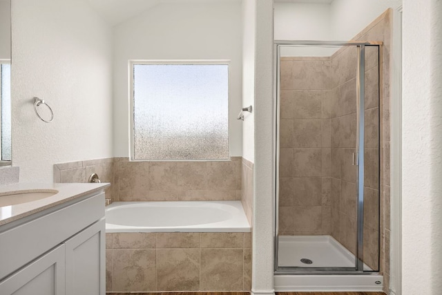 full bathroom with a healthy amount of sunlight, a stall shower, vanity, and a garden tub