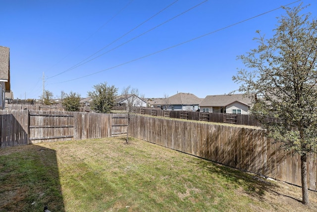 view of yard with a fenced backyard