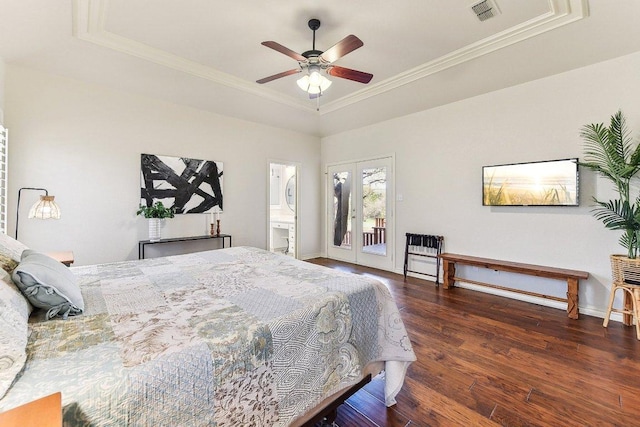 bedroom with visible vents, a tray ceiling, ornamental molding, wood finished floors, and access to outside