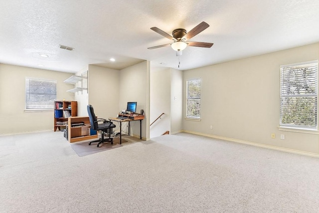 office space featuring baseboards, carpet floors, a textured ceiling, and ceiling fan