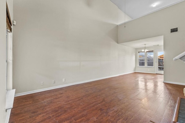 3609 Mims Cv, Austin, TX 78725 - unfurnished living room with a chandelier, wood finished floors, and a towering ceiling