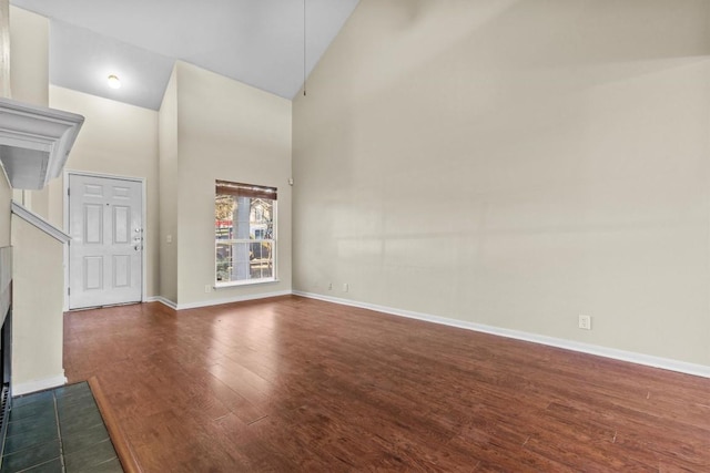 3609 Mims Cv, Austin, TX 78725 - unfurnished living room featuring high vaulted ceiling and dark wood-style floors