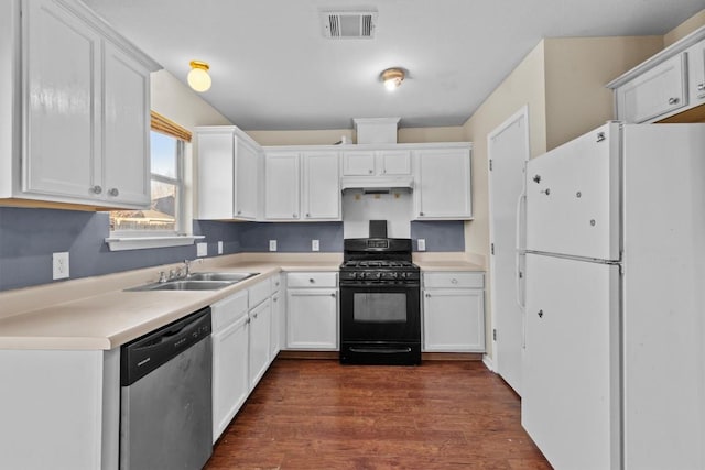 3609 Mims Cv, Austin, TX 78725 - kitchen with freestanding refrigerator, dishwasher, black gas stove, and white cabinets