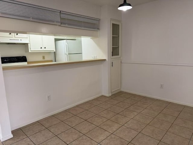 10616 Mellow Meadows Dr Unit 30-D, Austin, TX 78750 - kitchen featuring freestanding refrigerator, under cabinet range hood, range, white cabinetry, and tile patterned floors
