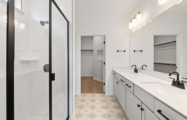 121 Crossbar St, Georgetown, TX 78633 - bathroom featuring a shower stall, tile patterned floors, double vanity, baseboards, and a spacious closet