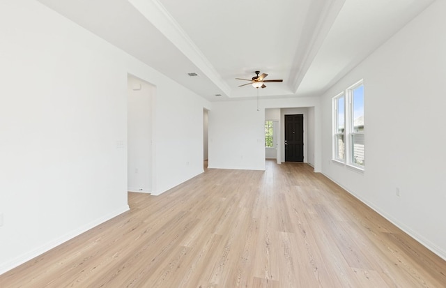 121 Crossbar St, Georgetown, TX 78633 - spare room with a tray ceiling, light wood-type flooring, ceiling fan, and baseboards