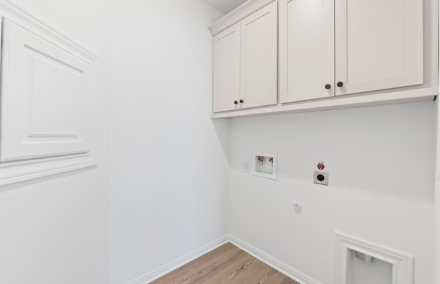 121 Crossbar St, Georgetown, TX 78633 - clothes washing area featuring electric dryer hookup, cabinet space, washer hookup, light wood finished floors, and baseboards