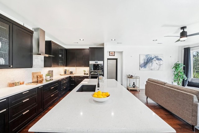 405 Rio, Horseshoe Bay, TX 78657 - kitchen with open floor plan, wall chimney exhaust hood, black electric stovetop, glass insert cabinets, and a spacious island