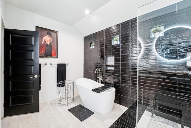 405 Rio, Horseshoe Bay, TX 78657 - full bath featuring tile walls, a soaking tub, lofted ceiling, a stall shower, and recessed lighting