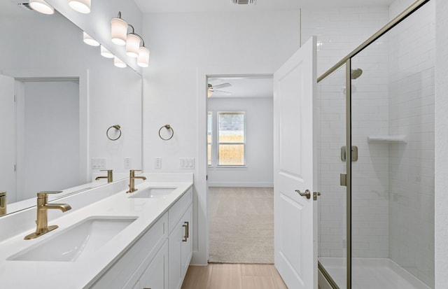585 Tailwind Dr, Kyle, TX 78640 - full bath featuring a shower stall, double vanity, and a ceiling fan